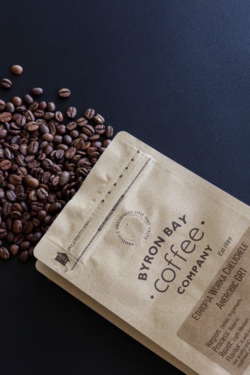 Coffee beans coming out of a bag labeled as Ethiopian Single Origin coffee