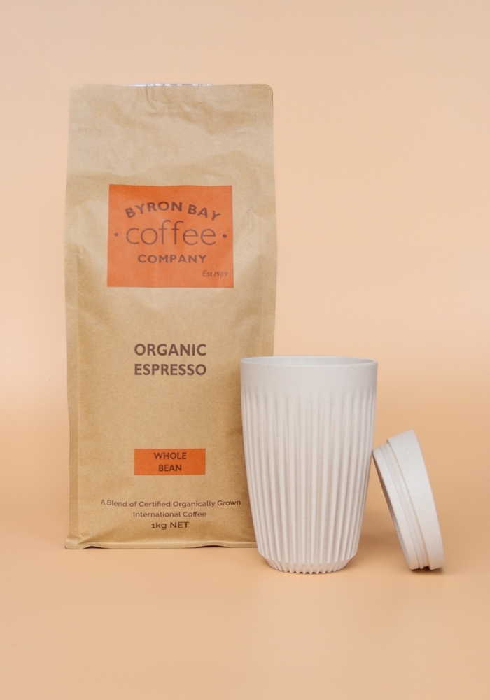 A bag of 1kg Organic Coffee next to a White Huskee Keep Cup