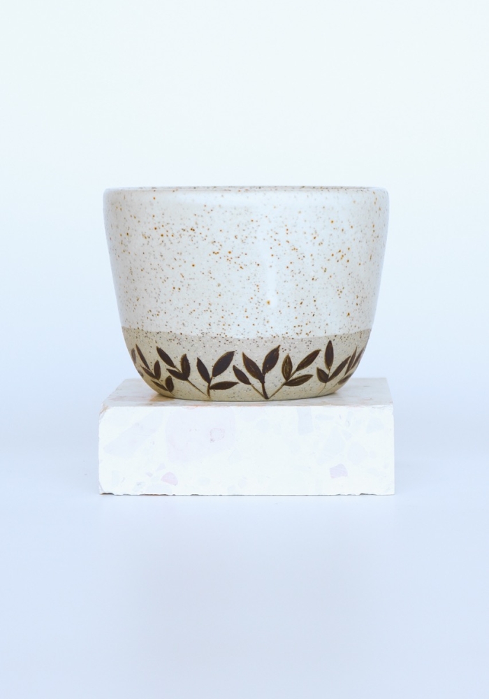 Handcrafted coffee cup with hand painted leaf motifs